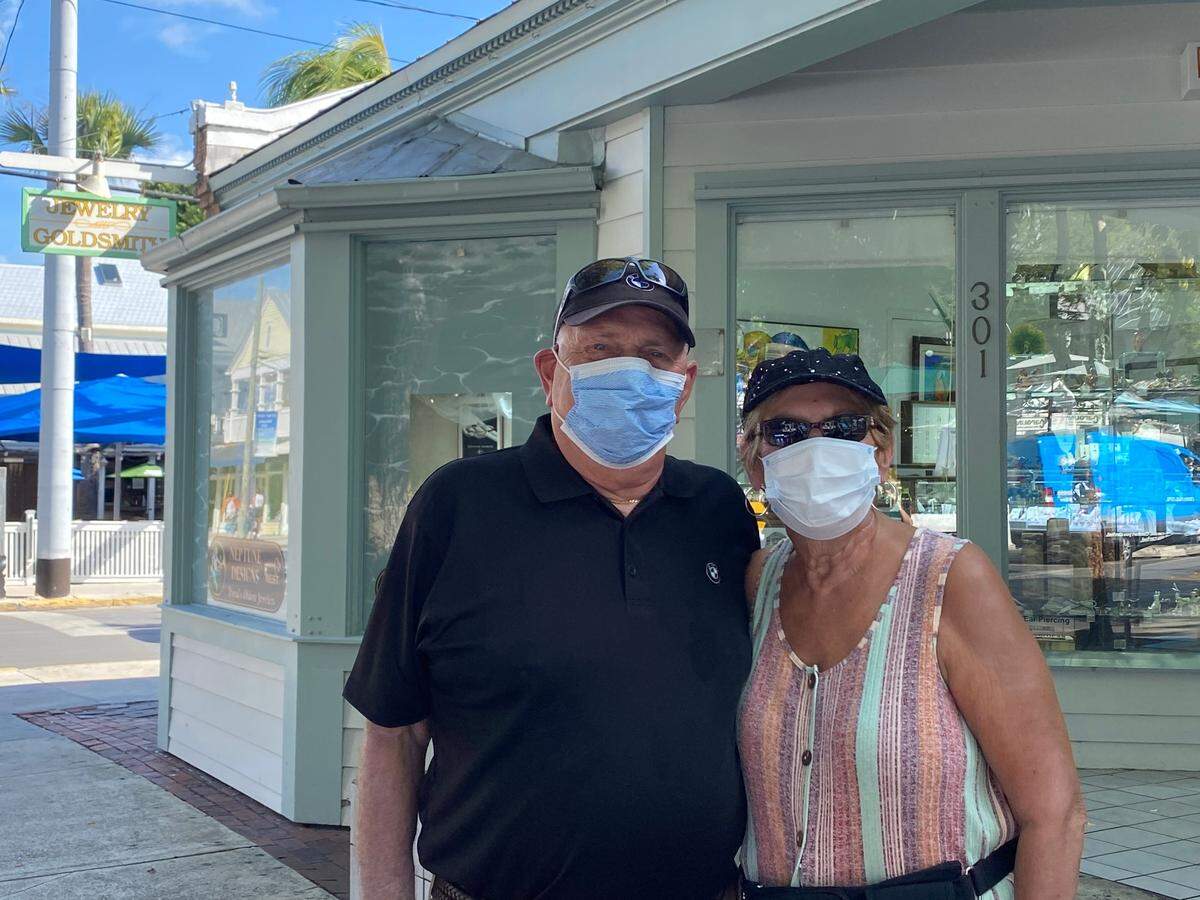 A Boynton Beach couple wear masks while strolling Duval Street in Key West on July 16, 2020.