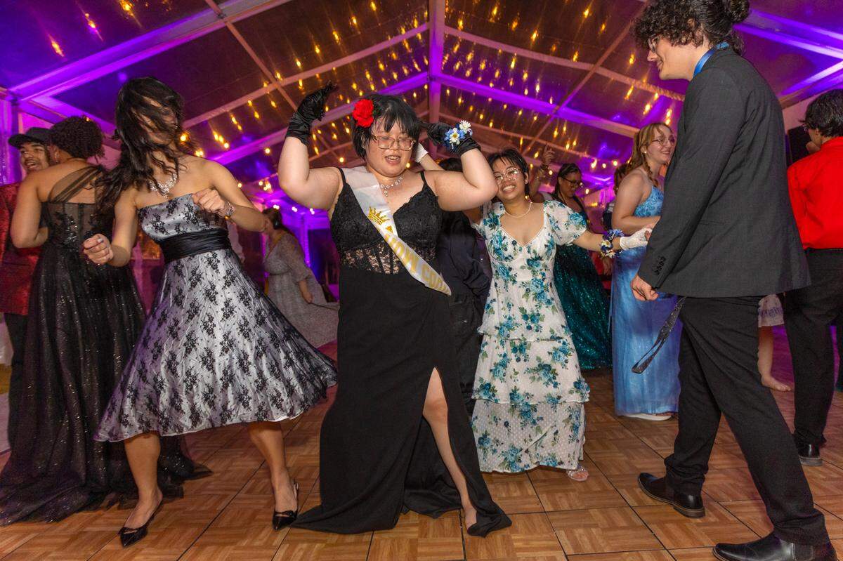Everglades High School’s Tuyetnhi Pham, 18, the Monarch of the Prom, seen at center, joins fellow students at Safe Schools South Florida’s prom for queer youth. The event provided students with the full prom experience in a welcoming and affirming space at the Vizcaya Museum and Gardens in Miami, Florida, on Saturday, May 31, 2025.