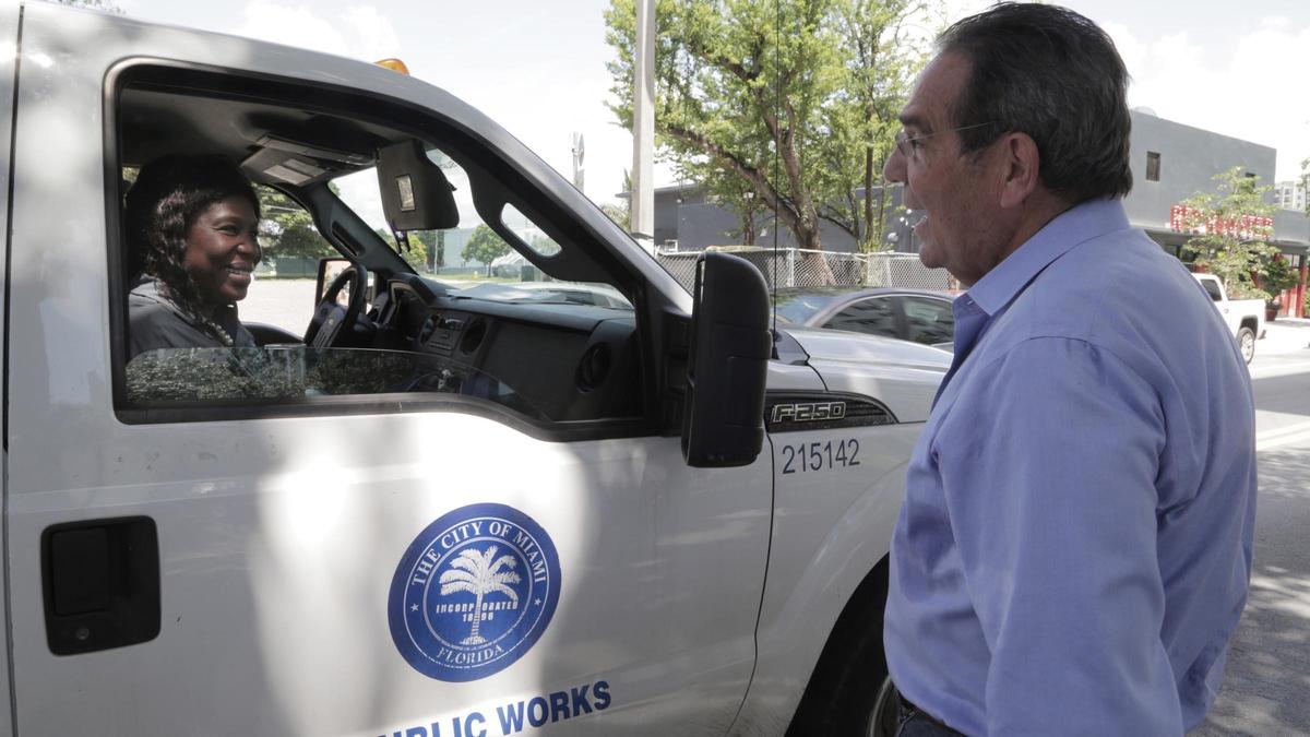County Commissioner Xavier Suarez, left, speaks to Miami-Dade County worker, Stacey Dean outside the Lyric Theater in Overtown on June 23, 2020.