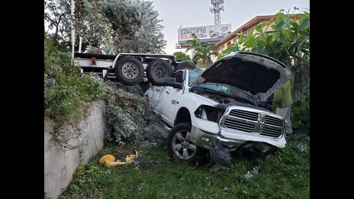 A Dodge Ram truck under the trailer it was pulling after crashing off Interstate 95 southbound Sunday morning.