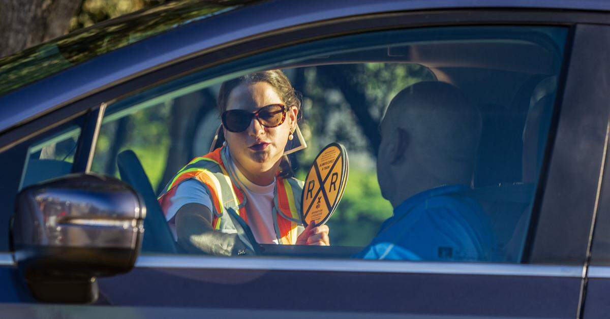 Ana Perez with the FDOT handed pamphlets to commuters, during the Operation Clear Track, to monitor railroad grade crossings for an opportunity to share the rail safety method with the community, wit the goal to reduce pedestrian and driver injuries and fatalities around railroad tracks increasing public awareness on the issue, in Miami, on Tuesday September 16, 2025.