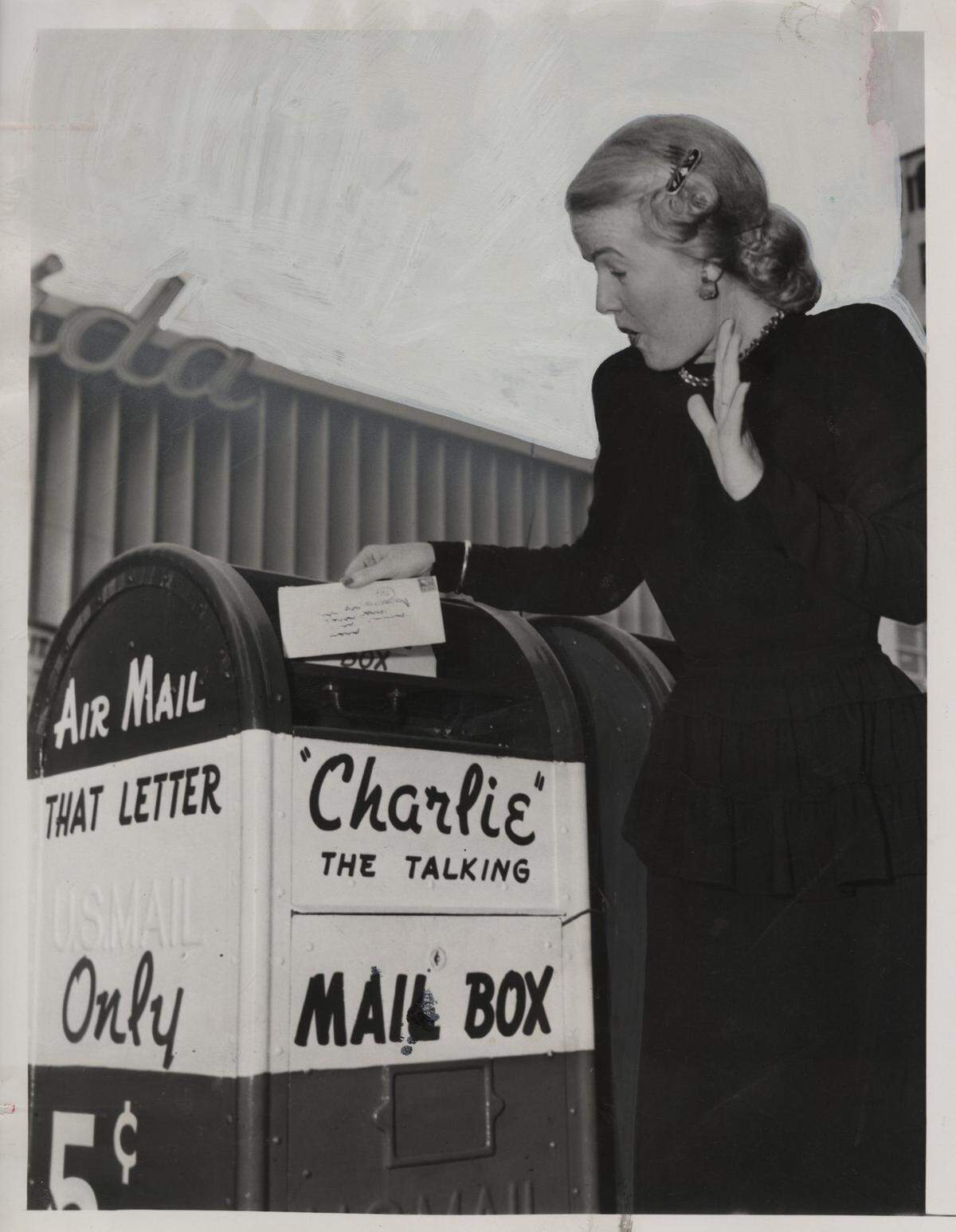 5/19/1948: Back talk from mailbox surprises Miss Lois Hathaway of 323 SE First Ave., as she mails a letter on East Flagler Street and Southeast  Second Ave., “Charlie the Talking Mail Box.”
