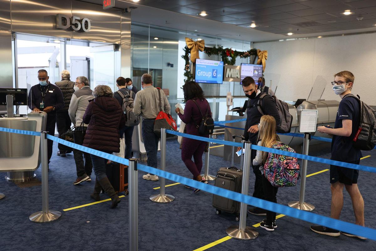 Passengers check in for American Airlines Flight 718, a Boeing 737 Max, at Miami International Airport for their flight to New York on Dec. 29, 2020, in Miami. The Boeing 737 Max flew its first U.S. commercial flight since the aircraft was allowed to return to service nearly two years after being grounded worldwide following a pair of separate crashes.