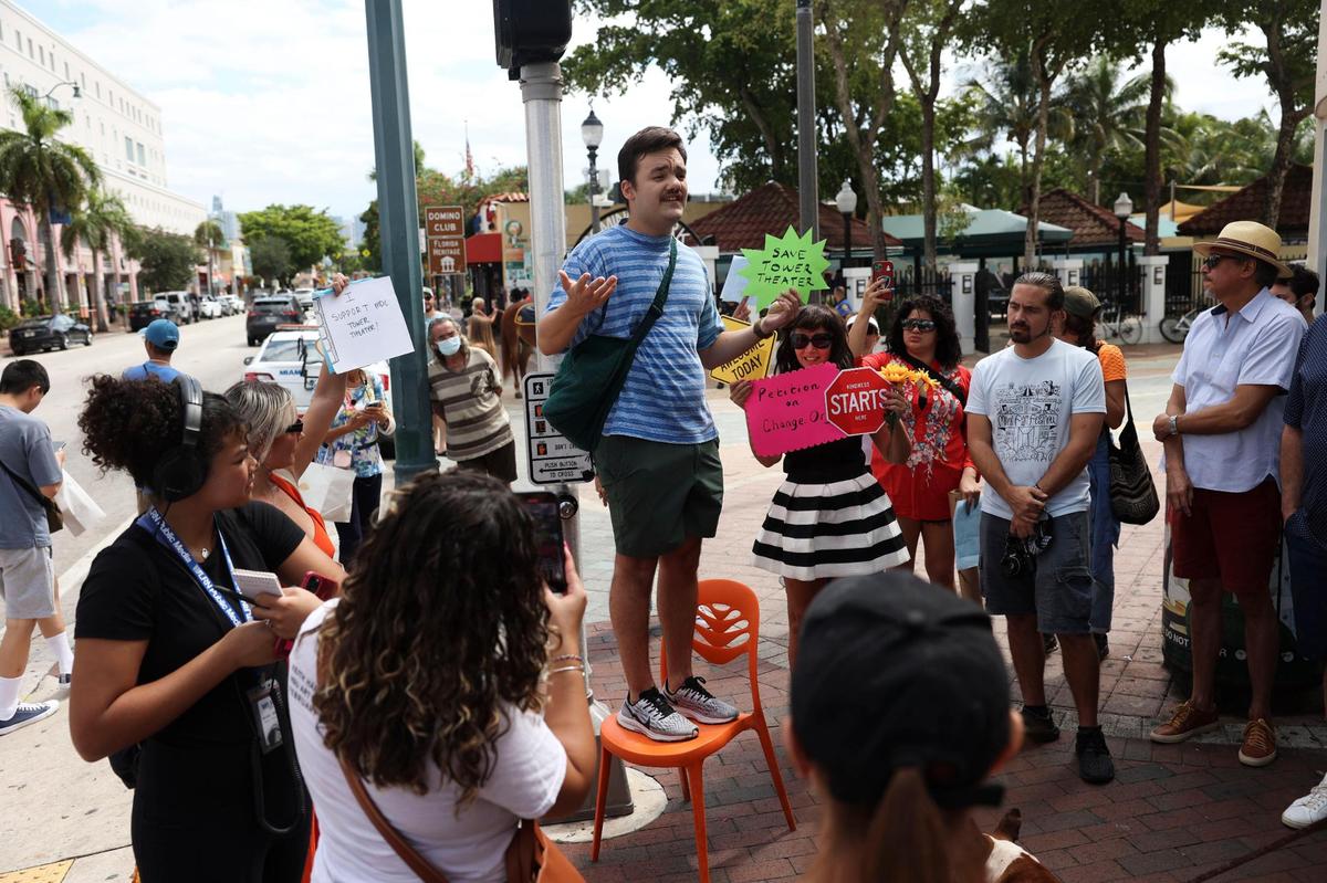 Chris Molina, cineasta local, se sube a una silla afuera del Tower Theater durante la protesta por la salida del Miami-Dade College como operador del lugar, el martes 4 de octubre de 2022, en La Pequeña Habana.
