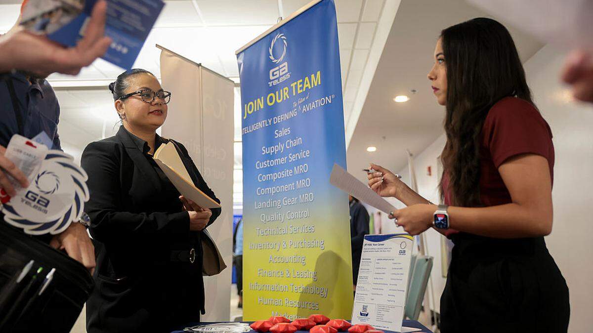 Katherine Sloan speaks with recruiter Dalia Sevilla Rubio during a CareerSource South Florida job fair held at Miami International Airport for former Spirit Airlines employees on May 7, 2026.