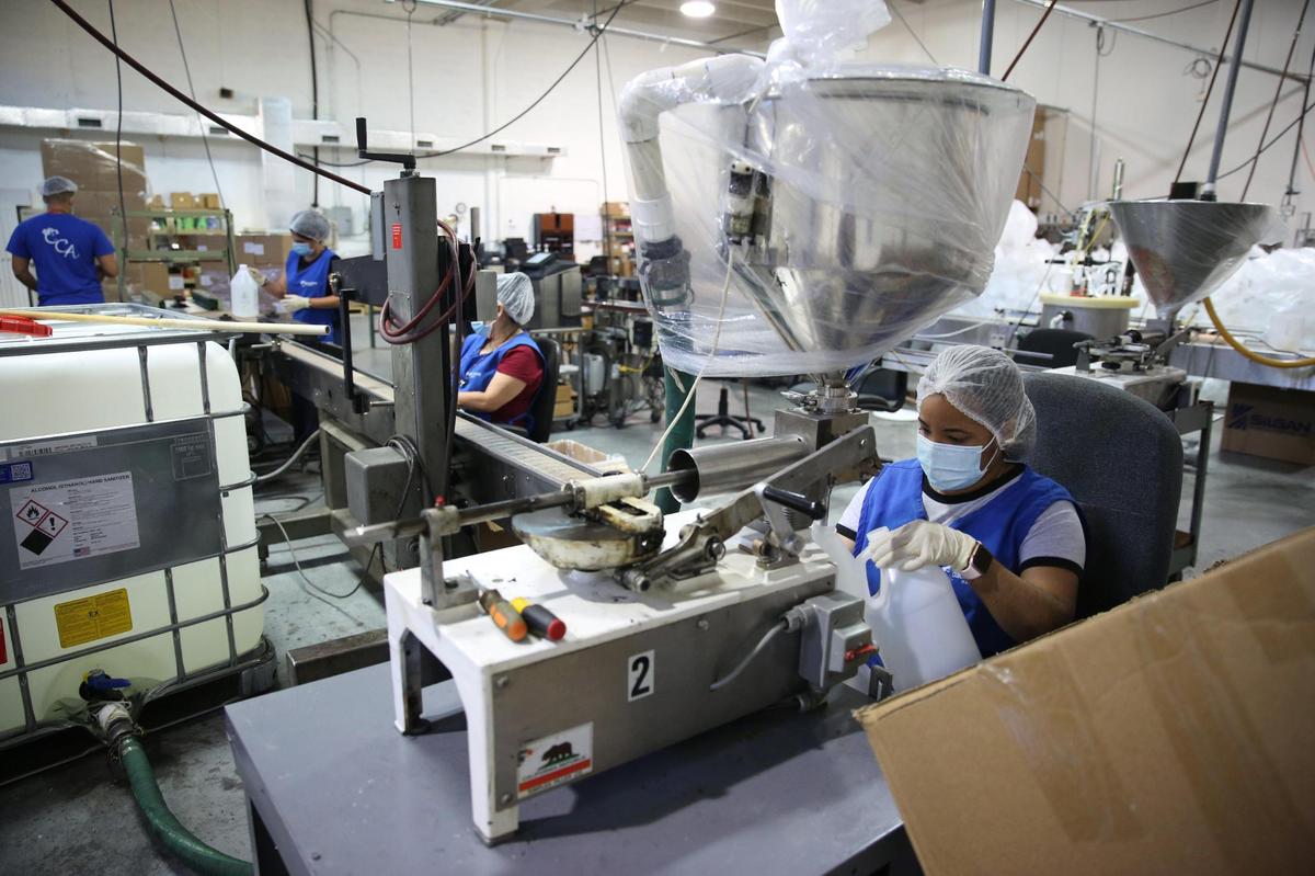 Dianelys Perez fills plastic bottles with EZ Hand Sanitizer at the production facility inside of the Cosmetic Corp Lab in Medley where the final product is made and assembled. Cosmetic Corp. partnered with Toast Distillers, Inc. to use Toast’s alcohol to create hand sanitzer products. Due to the coronavirus pandemic Toast distillers began distributing the product to help meet the global demand for hand sanitizers both at the government level as well as the local level.