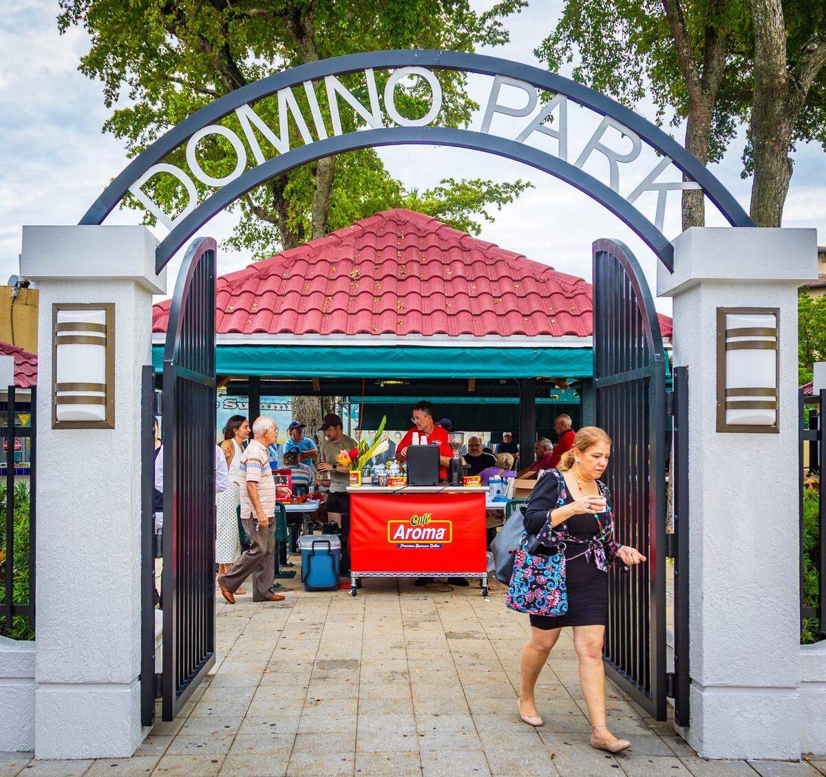 A visitor leaves Domino Park in Little Havana after grabbing a café aroma espresso coffee for free on Tuesday, Sept. 17, 2024, in Miami, Fla.