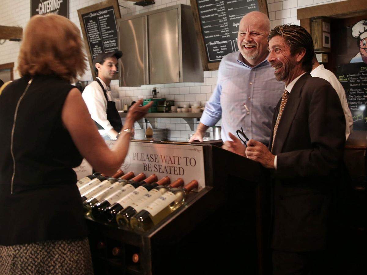 Managers chat with a customer at Perricone’s in 2015.