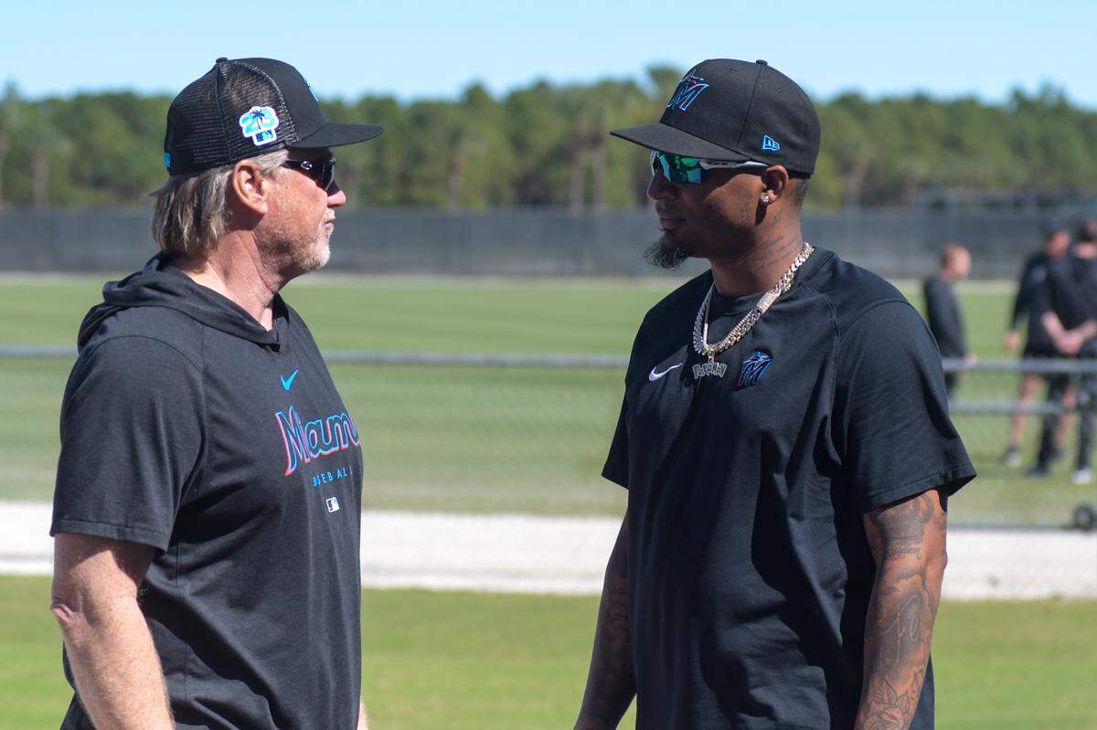 Miami Marlins pitching coach Mel Stottlemyre Jr. talks with pitcher Sixto Sanchez on the back fields of the Roger Dean Chevrolet Stadium complex in Jupiter, Florida, on Monday, Feb. 13, 2023.