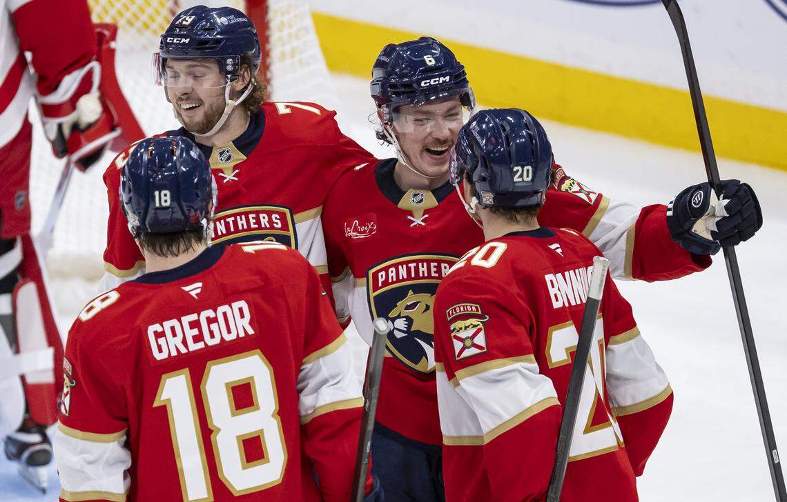 Florida Panthers defenseman Mike Benning (20) celebrates with defenseman Donovan Sebrango (6), center Cole Schwindt (79) and left wing Noah Gregor (18) after scoring against Detroit Red Wings goaltender Cam Talbot (39) in the second period of their NHL game at the Amerant Bank Arena on Wednesday, April 15, 2026, in Sunrise, Fla.