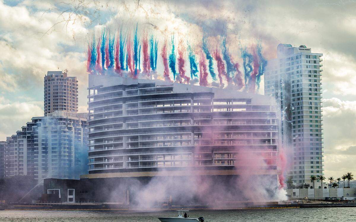 Plumes of pink and blue smoke announced the beginning of the controlled implosion of the Mandarin Oriental, Miami on Brickell Key.