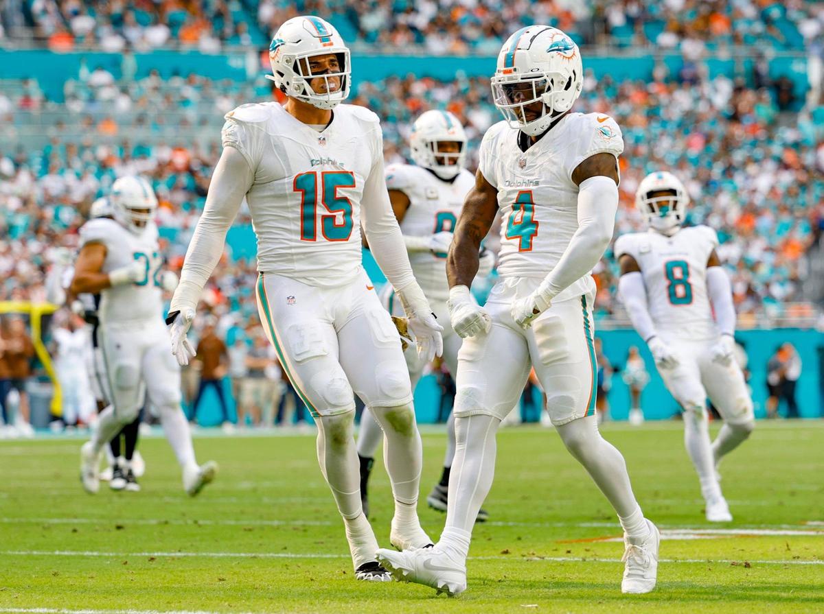 Miami Dolphins linebacker Jaelan Phillips (15) and cornerback Kader Kohou (4) react after Kohou tackles Las Vegas Raiders wide receiver Hunter Renfrow (13) in the first half at Hard Rock Stadium in Miami Gardens on Sunday, November 19, 2023.