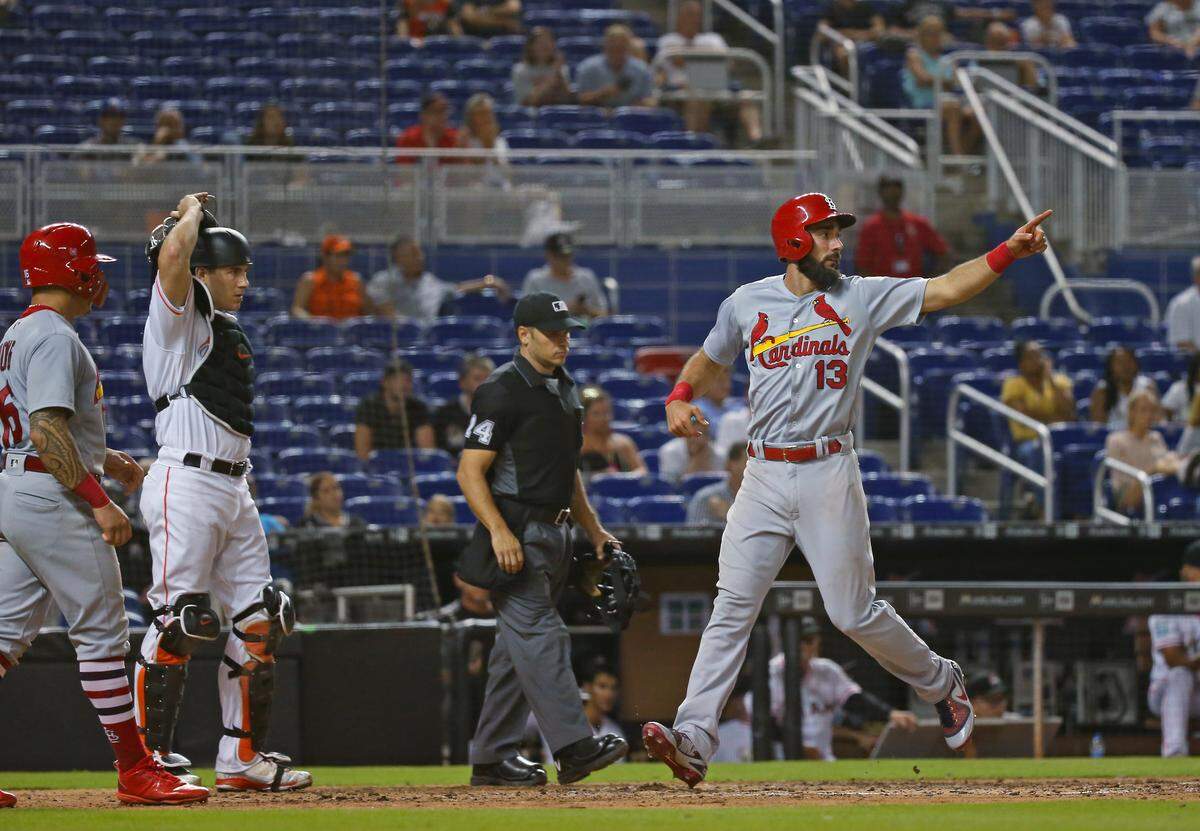 St. Louis Cardinals first baseman Matt Carpenter #13 scores on a two RBI double by catcher Yadier Molina during the ninth inning of a Major League Baseball game against the Miami Marlins at Marlins Park on Wednesday, August 8, 2018.
