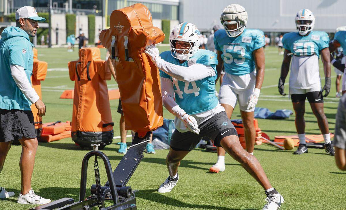 Miami Dolphins linebacker Chop Robinson (44) runs through drills