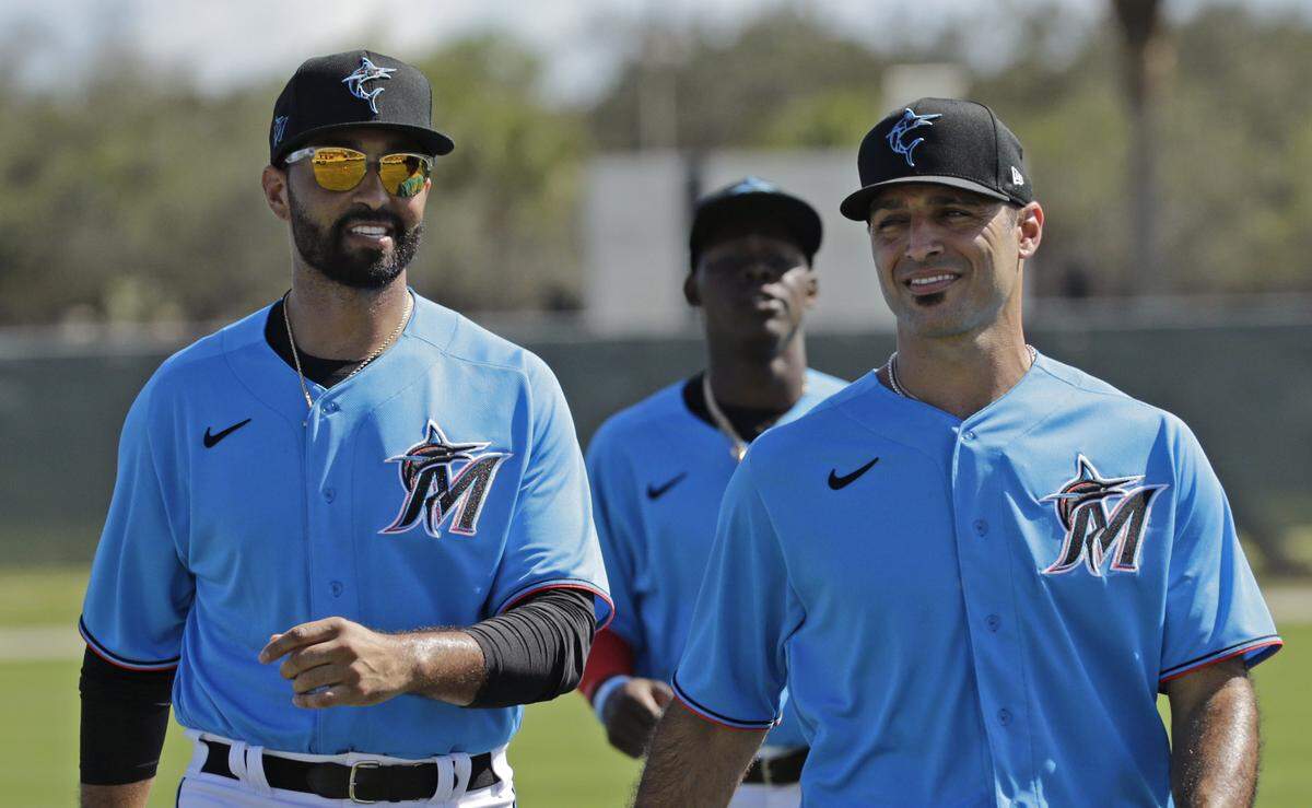 Miami Marlins outfielder Matt Kemp (27) talks with infielder Sean Rodriguez during the first full-squad spring training workout at Roger Dean Stadium on Monday, February 17, 2020 in Jupiter, FL.
