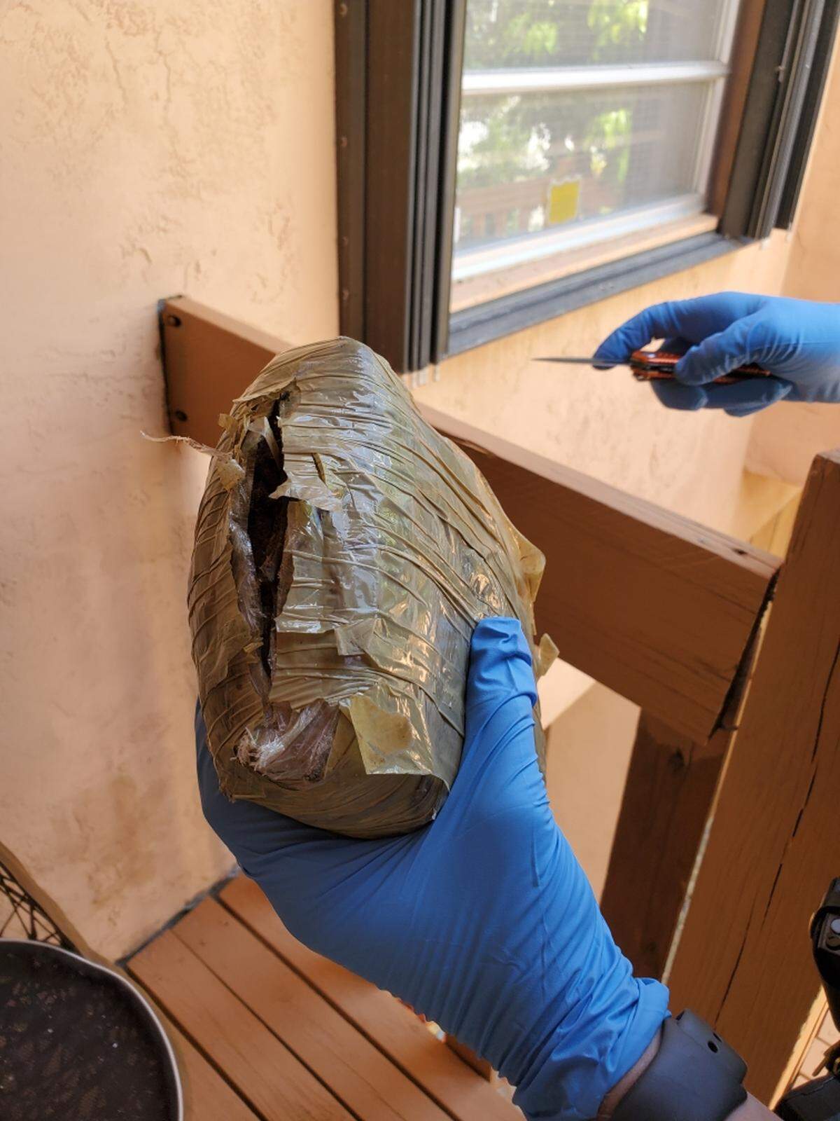 A Monroe County Sheriff’s Office deputy holds what police suspect to be a brick of marijuana that floated into a Key Largo canal on Tuesday, Sept. 10, 2019.