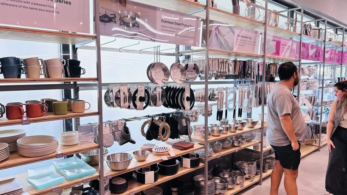 Stainless steel frying pans and other kitchen items at the new Kendall Higate Square Daiso on grand opening week of Feb. 19, 2026.