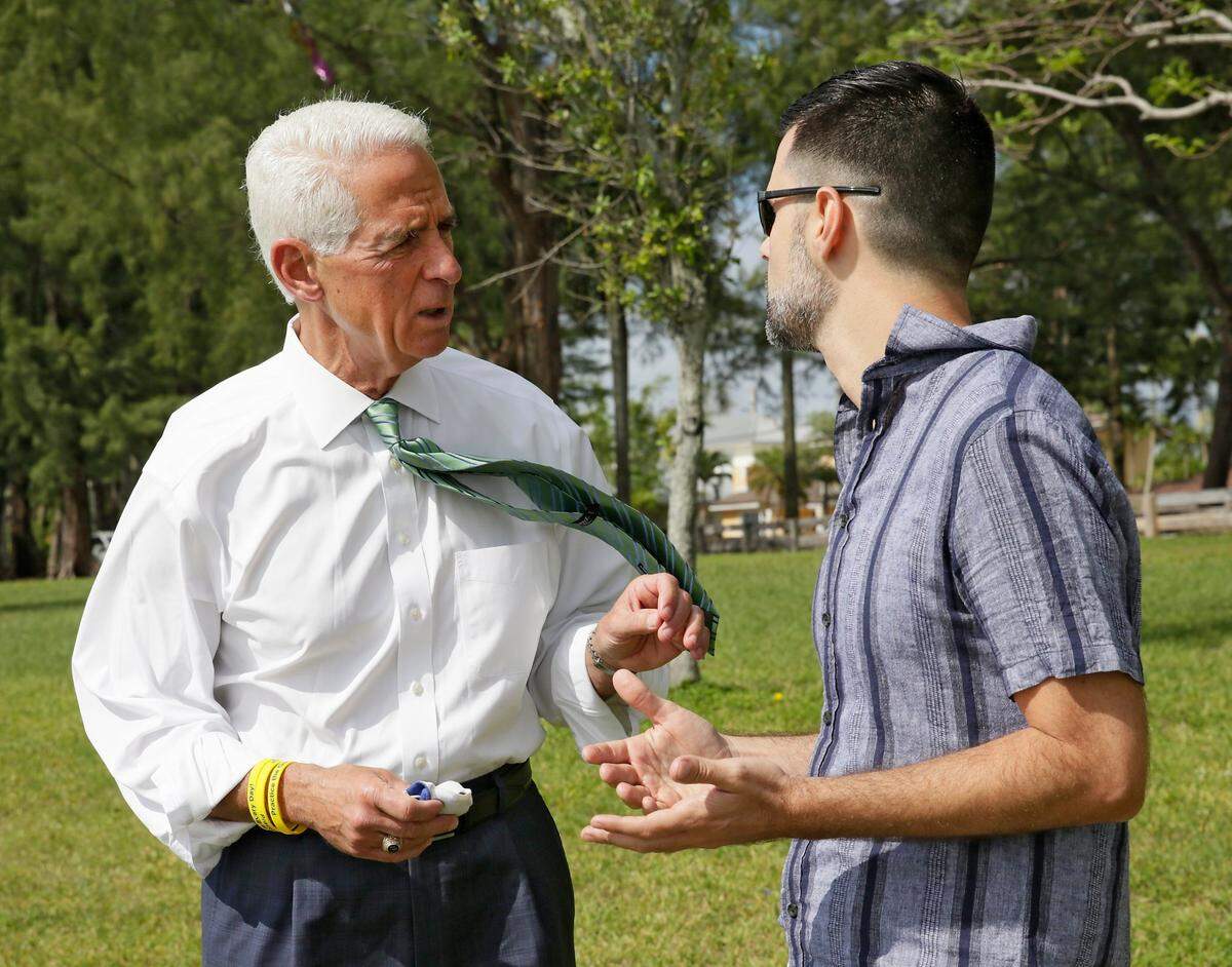 In this file photo from May 8, 2021, then-Democratic candidate for Florida governor Charlie Crist talks to Horacio Sierra, Cuban American Democratic Club president, during his meeting with Miami-Dade Democratic Cuban Americans at Tropical Park in Miami