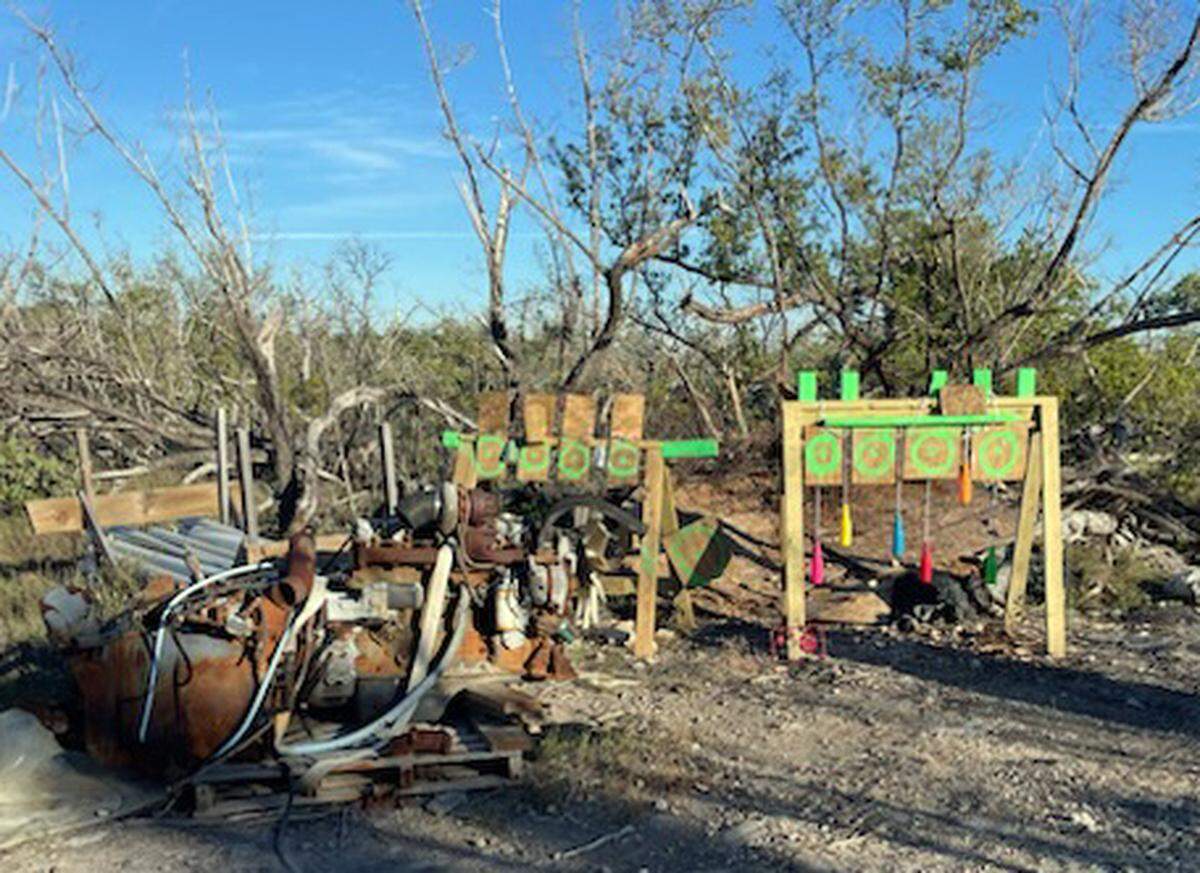 A collection of makeshift targets are placed in a yard at Kings Cove Road in Little Torch Key Thursday, Jan. 9, 2025. The Monroe County Sheriff’s Office said three people shooting at the targets hit a nearby home.