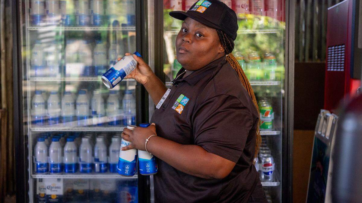 Ashanti Major, an employee at Zoo Miami, grabs aluminum water bottle’s out of the concession stand at Zoo Miami. The zoo cut 340,000 bottles of plastic from the waste system last year.
