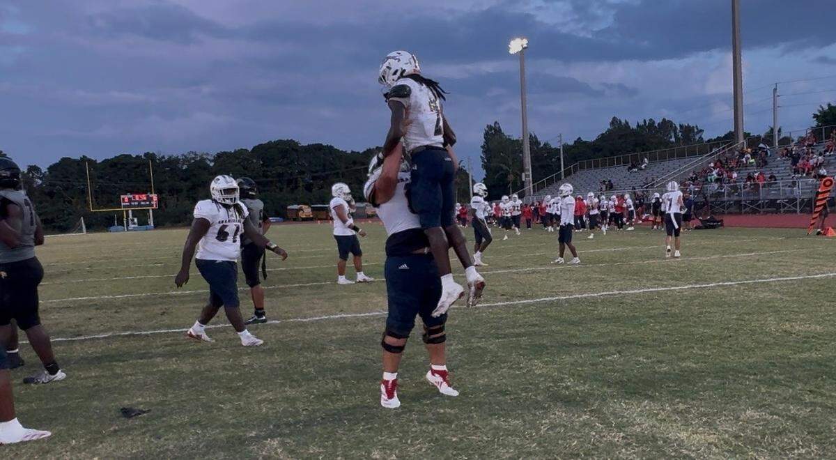 Chaminade running back Arwin Jackson is lifted up by a teammate in celebration following his touchdown run in the first quarter of Friday’s 26-9 win over Western in Davie, Fla.