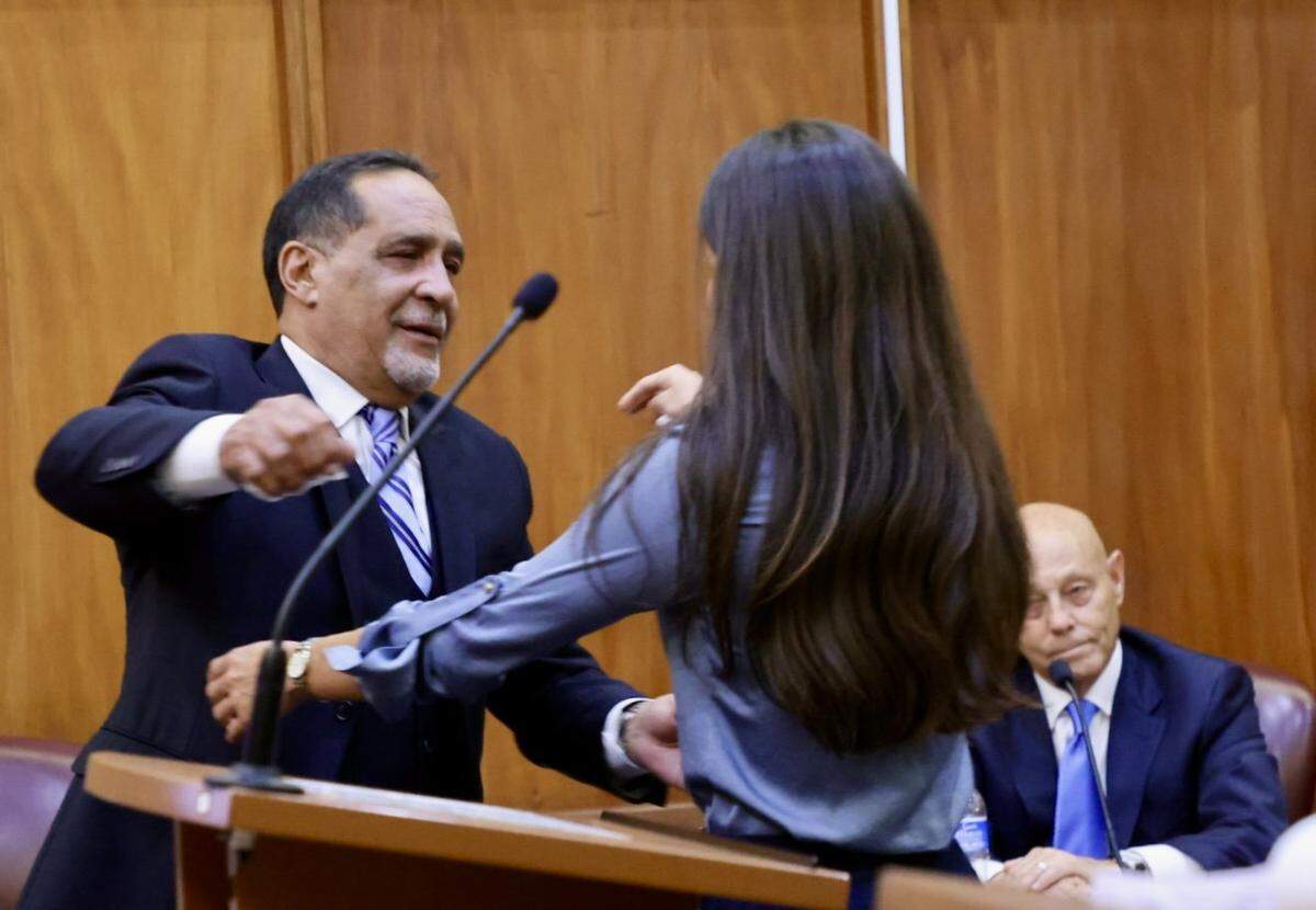 Miami, Florida, August 7, 2025 - Former Commissioner Joe Martinez, left, comforts his daughter Joana Martinez, right, after she testified on the character of her father during his sentencing trial.