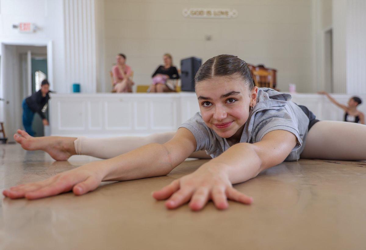 Abril Valentina Marinelli, a 15-year-old Argentian dancer, stretches on the floor before rehearsal at the Coral Gables First Church of Christ Scientist, one of the church sites that was repurposed into a dance studio by Sanctuary of the Arts.