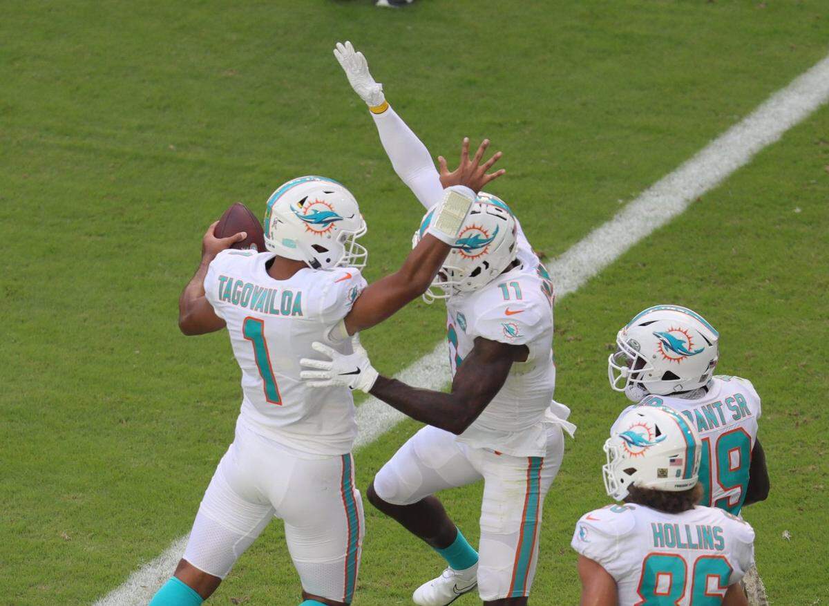Miami Dolphins quarterback Tua Tagovailoa (1) and wide receiver DeVante Parker (11) celebrate a first quarter touchdown against the Los Angeles Rams at Hard Rock Stadium in Miami Gardens on Sunday, November 1, 2020.
