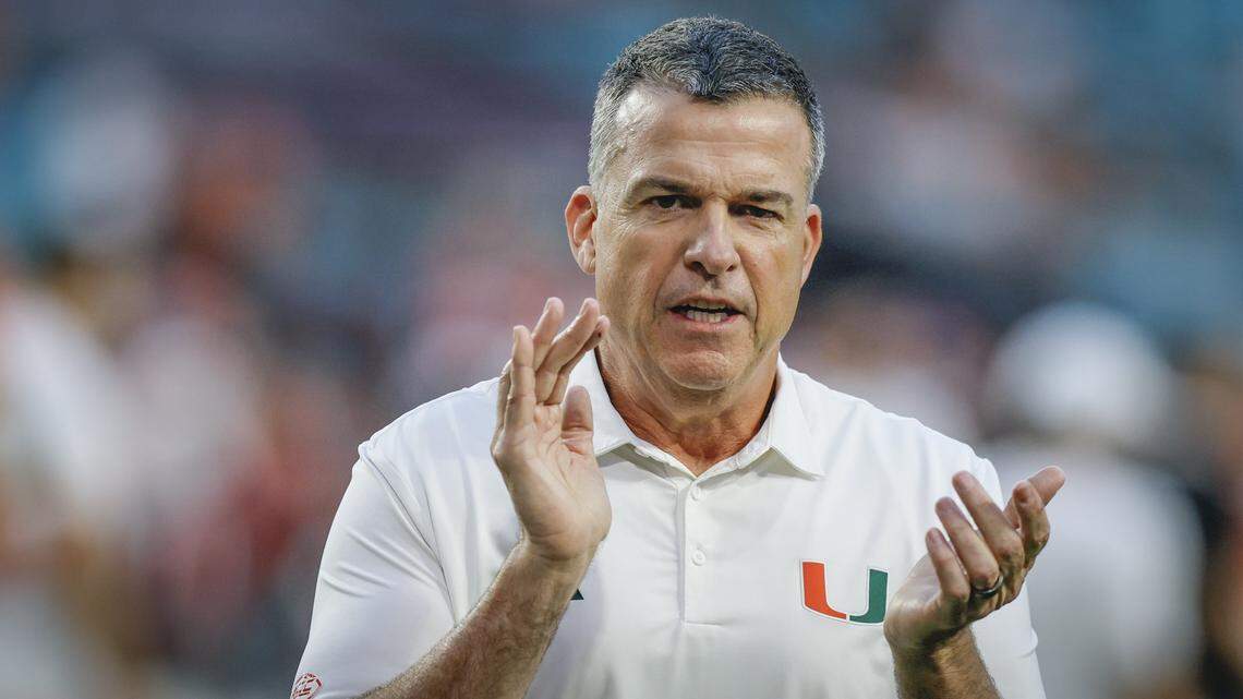 Miami Hurricanes head coach Mario Cristobal on the field for the start of the NCAA football game against the Louisville Cardinals at Hard Rock Stadium in Miami Gardens, Florida, on Friday, October 17, 2025.