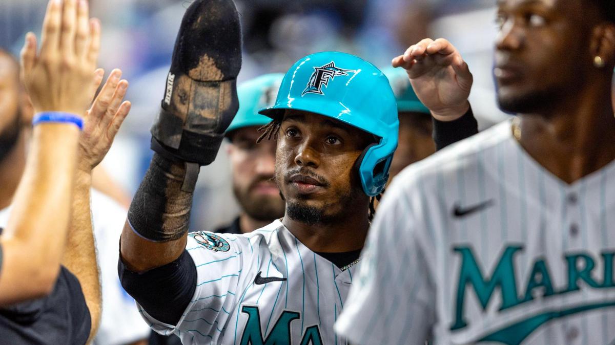 Miami Marlins batter Jean Segura (9) reacts with teammates after scoring off a Joey Wendle double during the second inning of an MLB game against the Philadelphia Phillies at loanDepot park in the Little Havana neighborhood of Miami, Florida, on Friday, July 7, 2023.