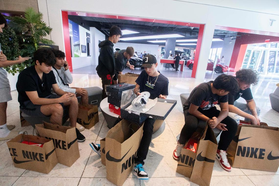 Miguel Camacho 17, center, surrounded by his friends Zayaan Yousuf, Roddy Eilon, Rd. Solez in Aventura Mall, during Black Friday Nov. 25, 2022.