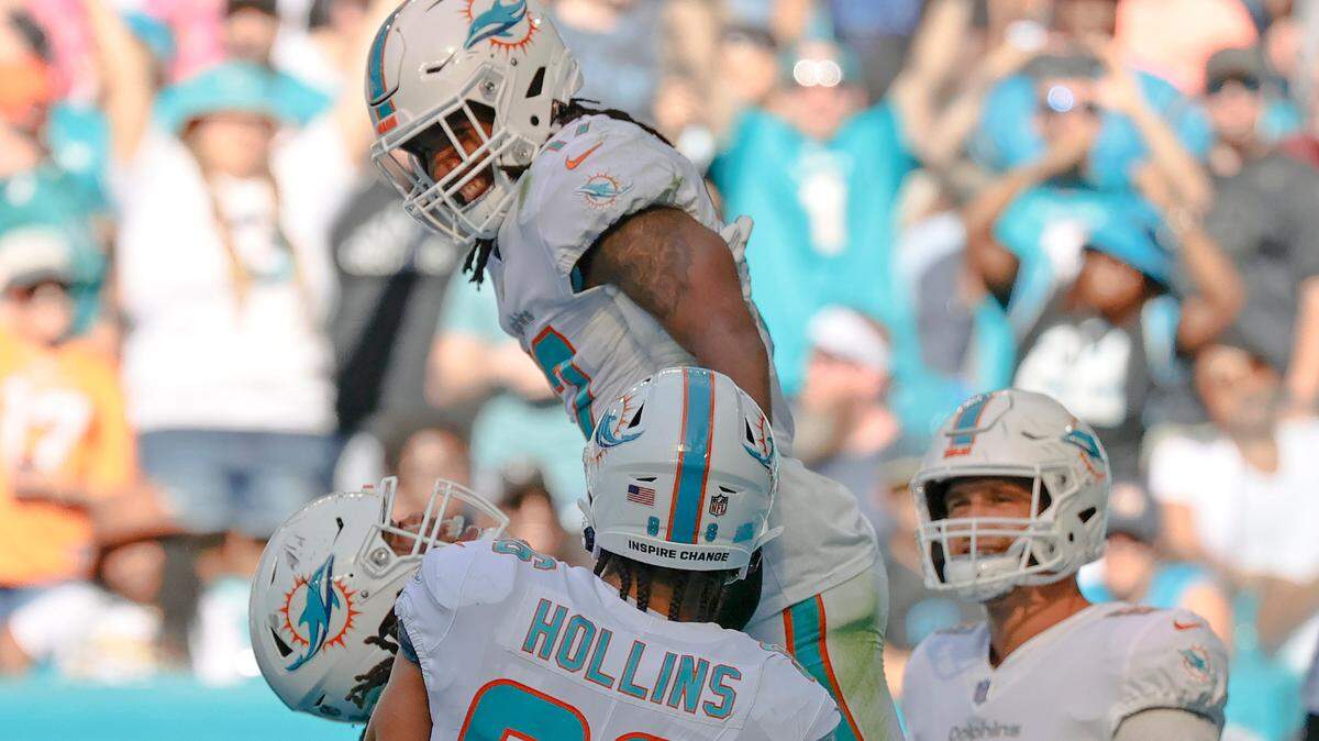 Miami Dolphins guard Robert Hunt (68) lifts Dolphins wide receiver Jaylen Waddle (17) rafter scoring a touchdown against Carolina Panthers during the second quarter of an NFL football game at Hard Rock Stadium on Sunday, November 28, 2021 in Miami Gardens, Florida.