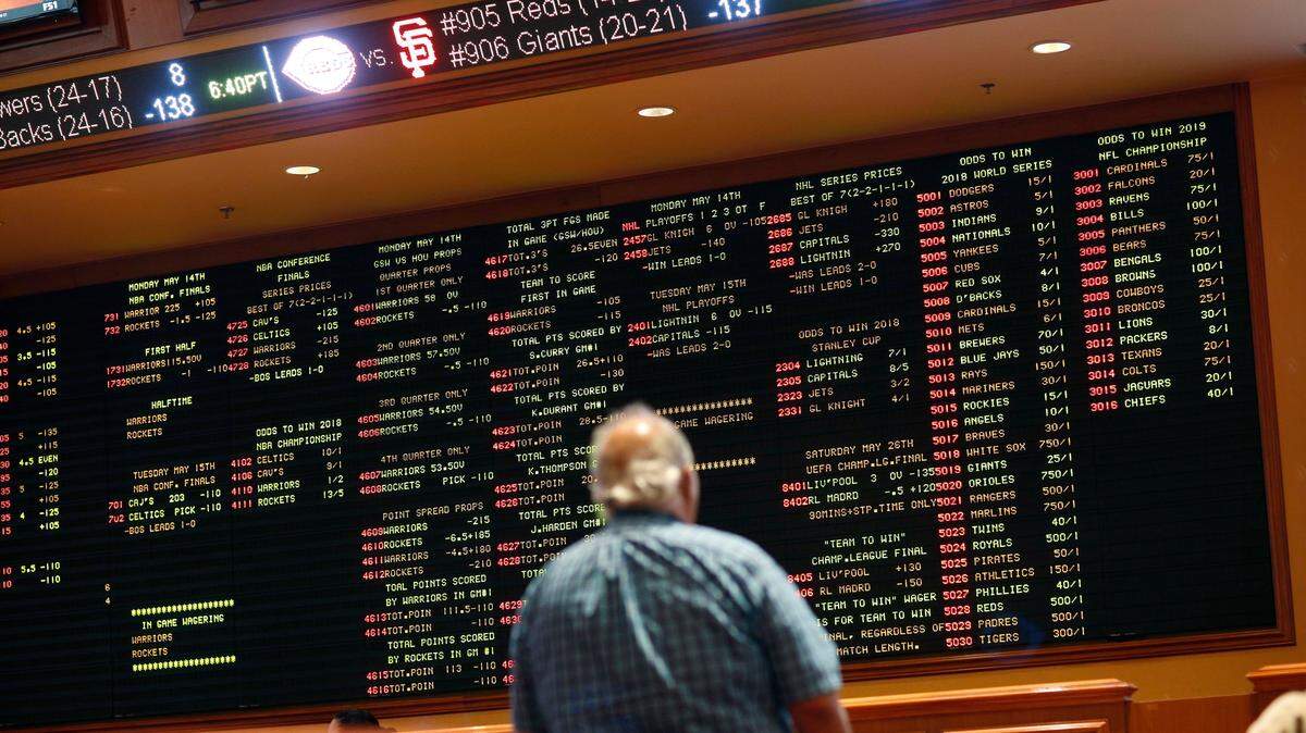In this Monday, May 14, 2018, file photo, betting odds are displayed on a board in the sports book at the South Point hotel and casino in Las Vegas.