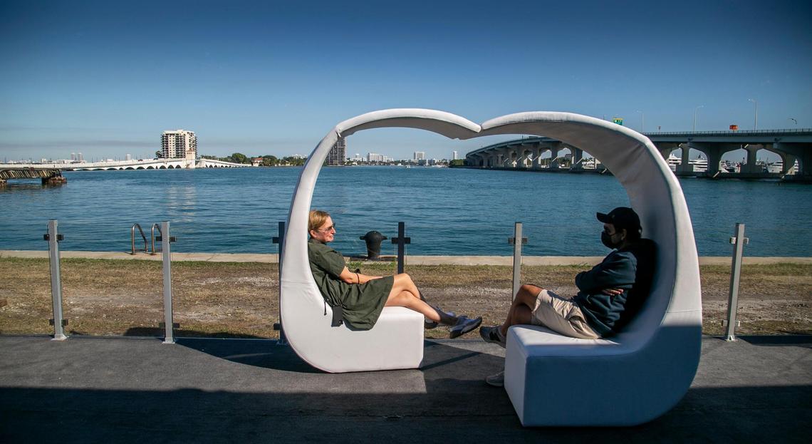 Miami, Florida, November 29, 2021 - workers take a break in the outdoor area at the Art Miami tent, One Herald Plaza.