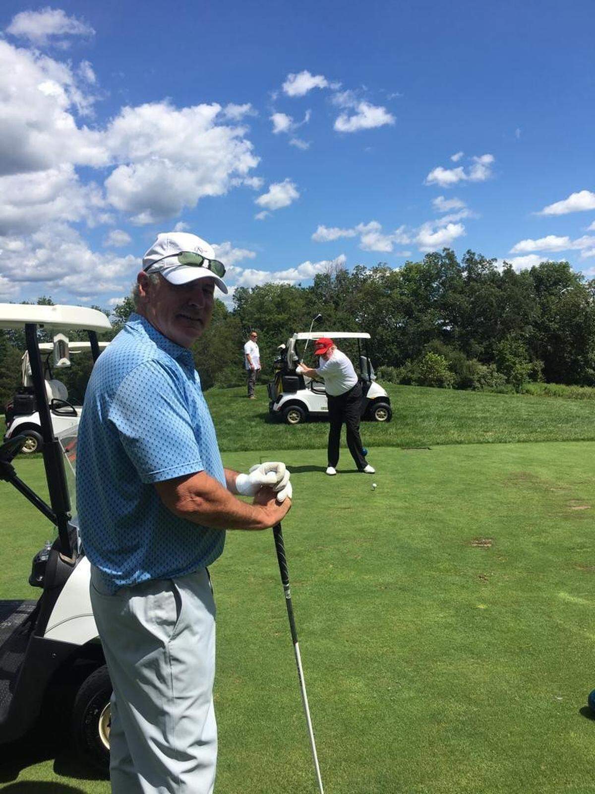 Florida magnate Harry Sargeant III is shown playing golf with Donald Trump.