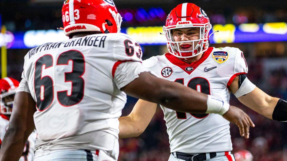 University of Georgia tight end Brock Bowers (19) celebrates with teammate offensive lineman Sedrick Van Pran- Granger (63) after scoring a touchdown against University of Michigan during the first quarter of the 2021 College Football Playoff Semifinal at the Capital One Orange Bowl hosted at Hard Rock Stadium in Miami Gardens, Florida, on Friday, December 31, 2021.