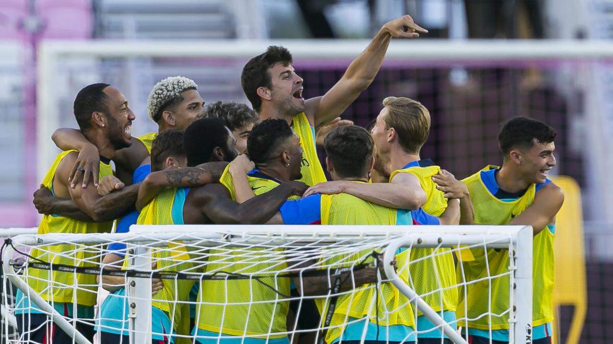 FC Barcelona defender Gerard Piqué (3), center, celebrates with teammates during an open training session in advance of their friendly soccer match against Inter Miami CF at DRV PNK Stadium on Monday, July 18, 2022.