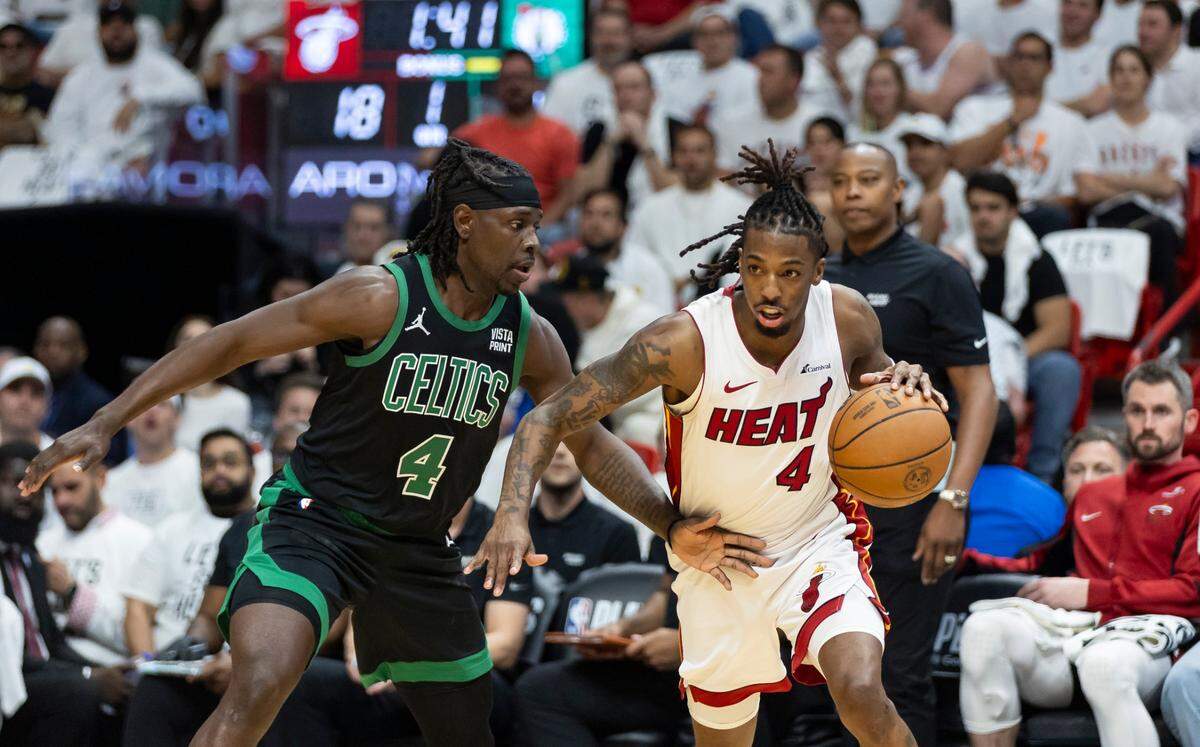 Miami Heat guard Delon Wright (4) drives the ball as Boston Celtics guard Jrue Holiday (4) defends in the first half of Game 4 of an NBA basketball first-round playoff series at Kaseya Center on April 29, 2024, in Miami.