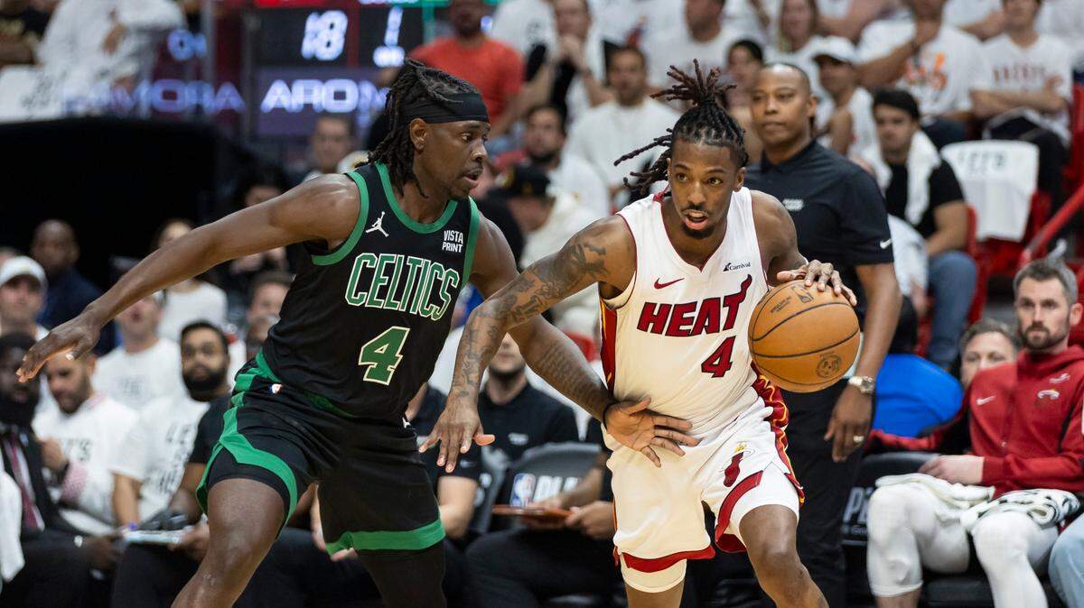 Miami Heat guard Delon Wright (4) drives the ball as Boston Celtics guard Jrue Holiday (4) defends in the first half of Game 4 of an NBA basketball first-round playoff series at Kaseya Center on April 29, 2024, in Miami.