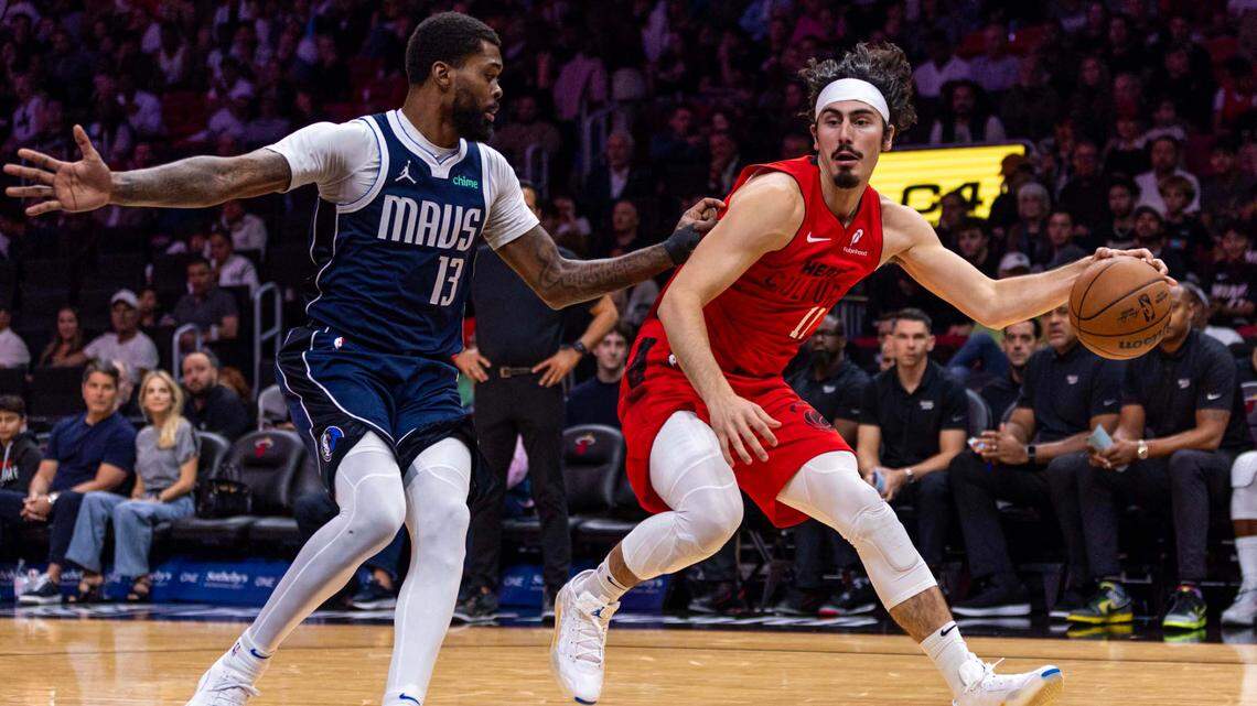 Miami Heat guard Jaime Jaquez Jr. (11) dribbles while defended by Dallas Mavericks forward Naji Marshall (13) during the first half of an NBA game at Kaseya Center on Nov. 24, 2024, in Miami.