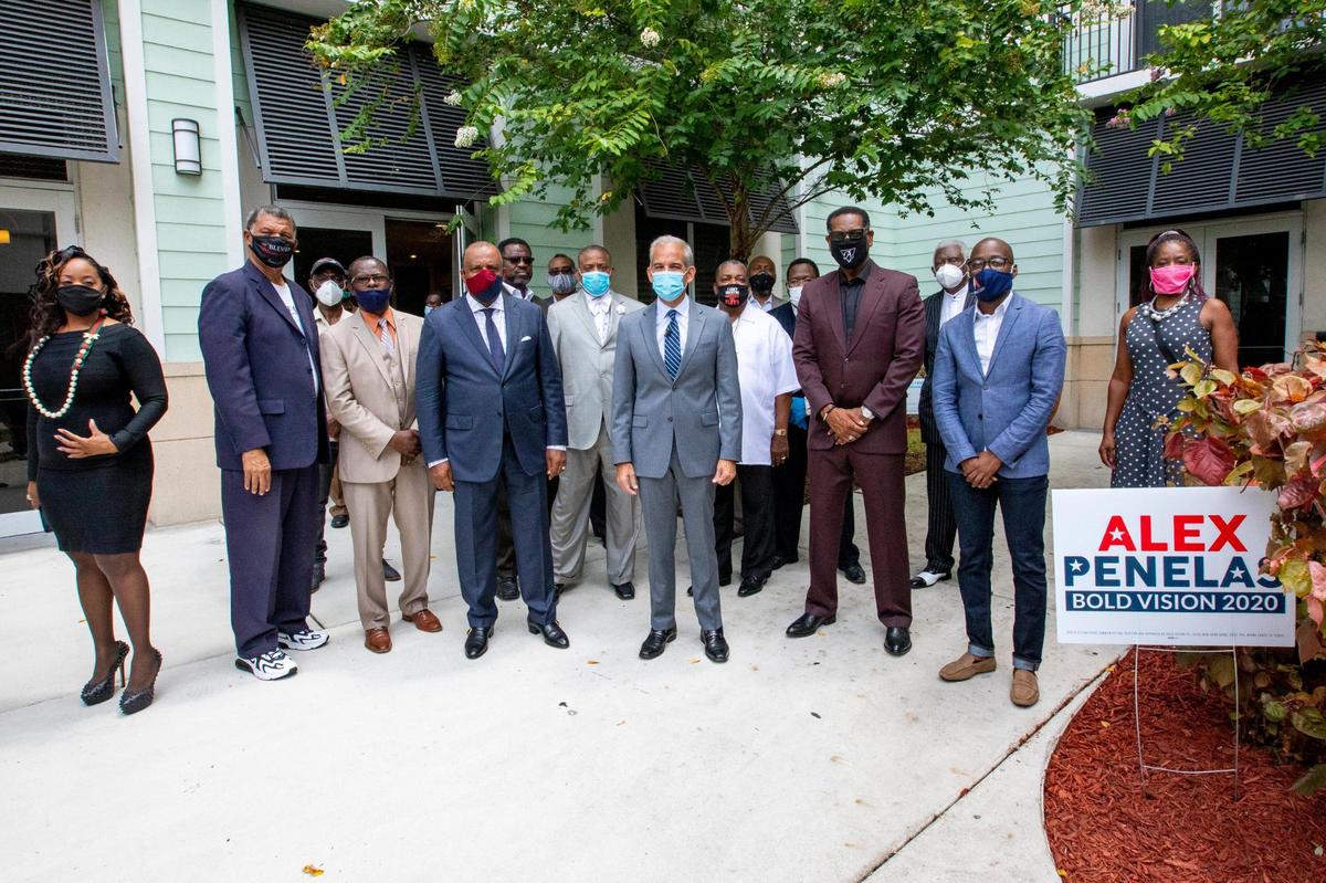 Miami-Dade mayoral candidate Alex Penelas and community pastors pose for a photo during a community event at Northside Transit Village in Miami, Florida on Friday, July 10, 2020.