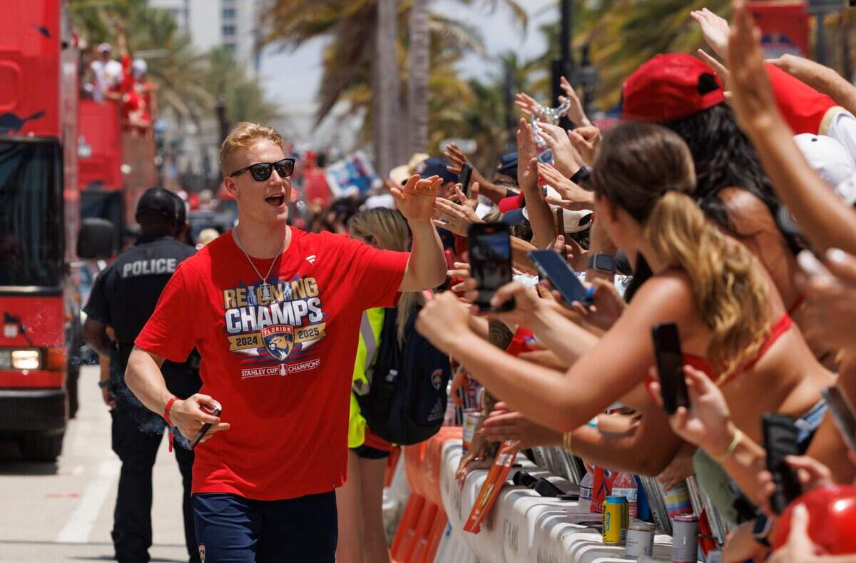 Florida Panthers defenseman Gustav Forsling (42) high fives fans during the Florida Panthers Stanley Cup Championship victory parade on Sunday, June 22, 2025, down Las Olas in Fort Lauderdale, Fla.