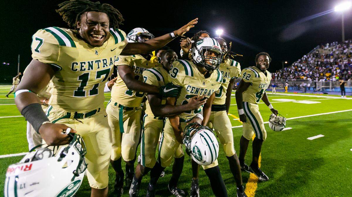 Miami Central Rockets kicker Jayden John (29), center, is congratulated by his teammates after kicking the game winning shot against the Northwestern Bulls on Friday, October 1, 2021 at Nathaniel Traz Powell Stadium in Miami, Florida.