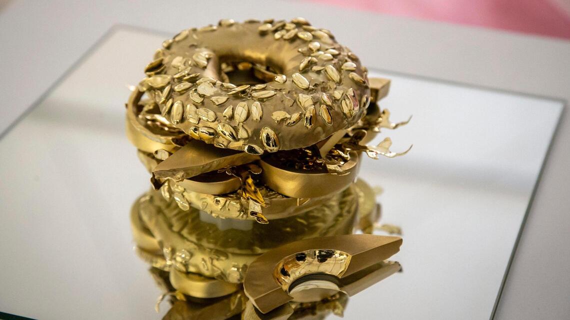 A superhuman size candle, a golden bagel, a rare chest: Guess how much this art costs