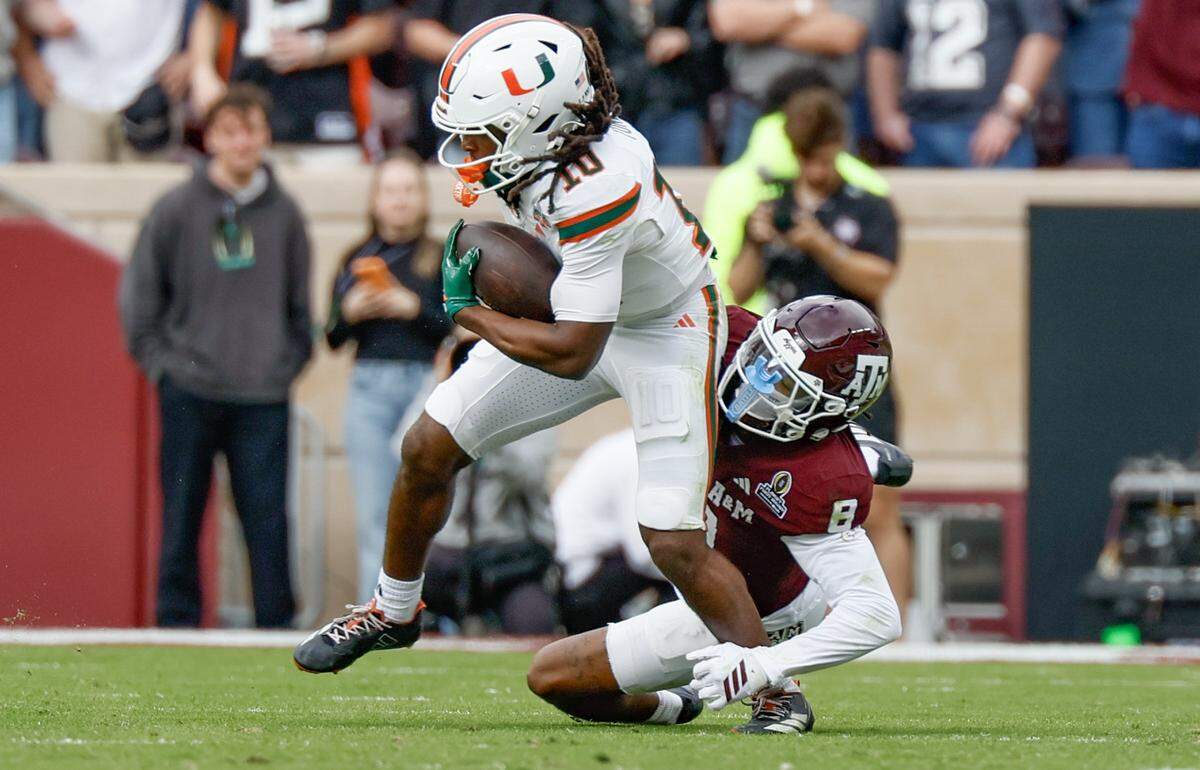 Miami Hurricanes wide receiver Malachi Toney (10) on a record breaking catch in the second quarter as Texas A&M Aggies cornerback Jordan Shaw (8) defends in the first round of the 2025 College Football Playoff at Kyle Field at College Station, Texas, on Saturday, December 20, 2025.