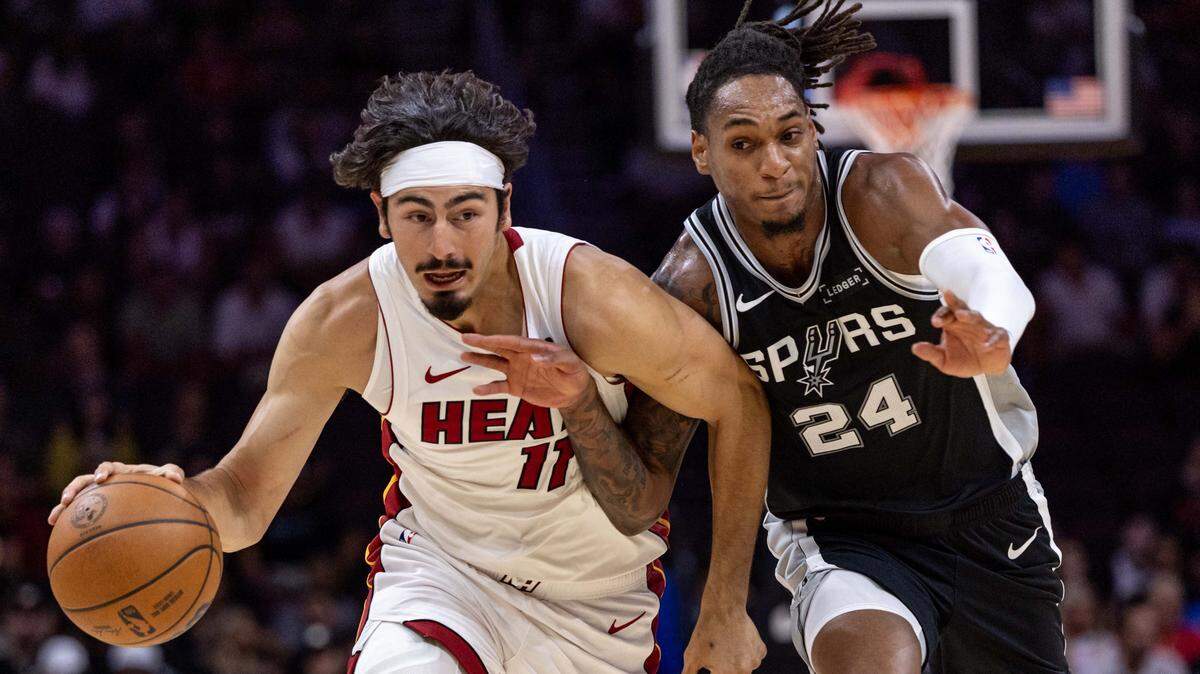 Miami Heat guard Jaime Jaquez Jr. (11) drives on San Antonio Spurs forward Devin Vassell (24) during an NBA preseason game at Kaseya Center on Wednesday, October  8, 2025, in Miami, Fla.
