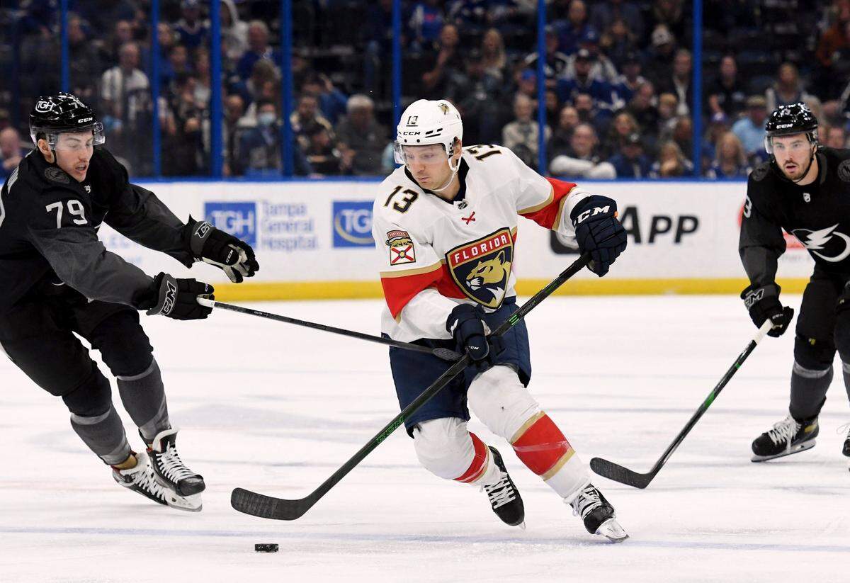 Florida Panthers center Sam Reinhart (13) handles the puck around Tampa Bay Lightning left wing Ross Colton (79) during the first period of an NHL hockey game Saturday, Nov. 13, 2021, in Tampa, Fla.