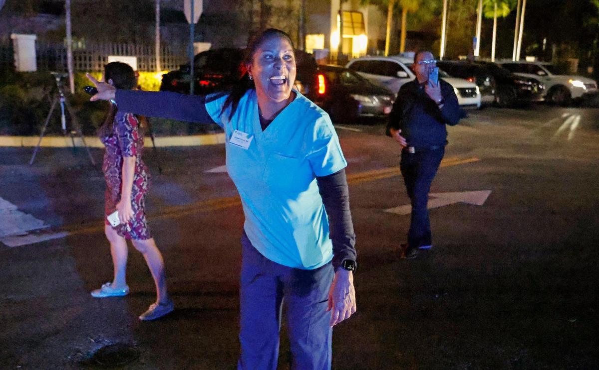 Elizabeth Corrales reacts after seeing a family member on a group of buses with Cuban migrants that arrived from the Florida Keys at the Border Patrol Station in Dania Beach on Thursday, Jan. 5, 2023.