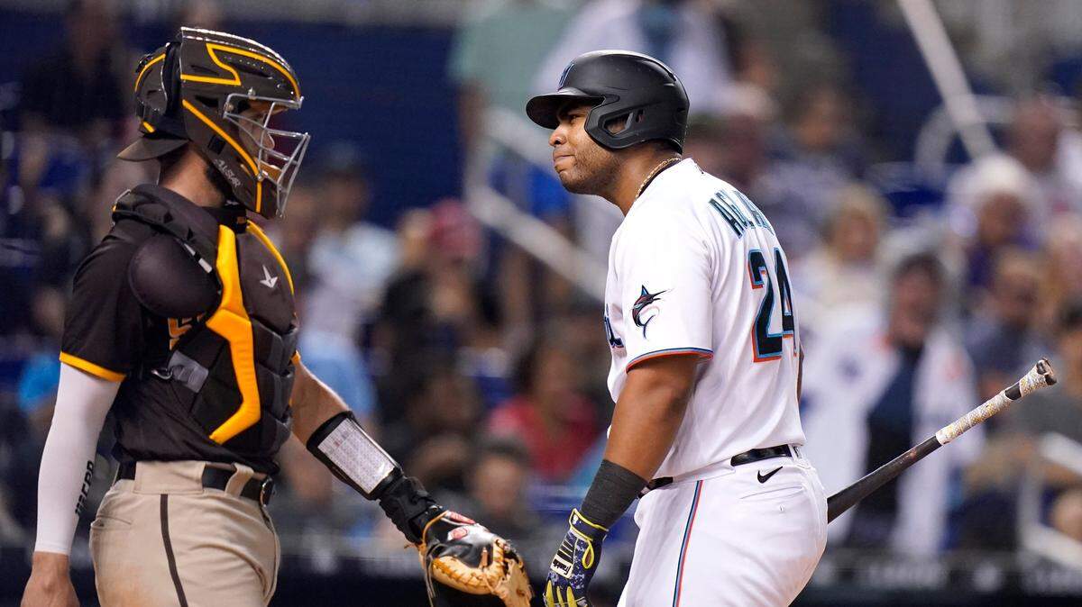 Miami Marlins’ Jesus Aguilar, right, reacts after striking out during the fourth inning of a baseball game, next to San Diego Padre catcher Austin Nola on Thursday, July 22, 2021, in Miami. (AP Photo/Lynne Sladky)