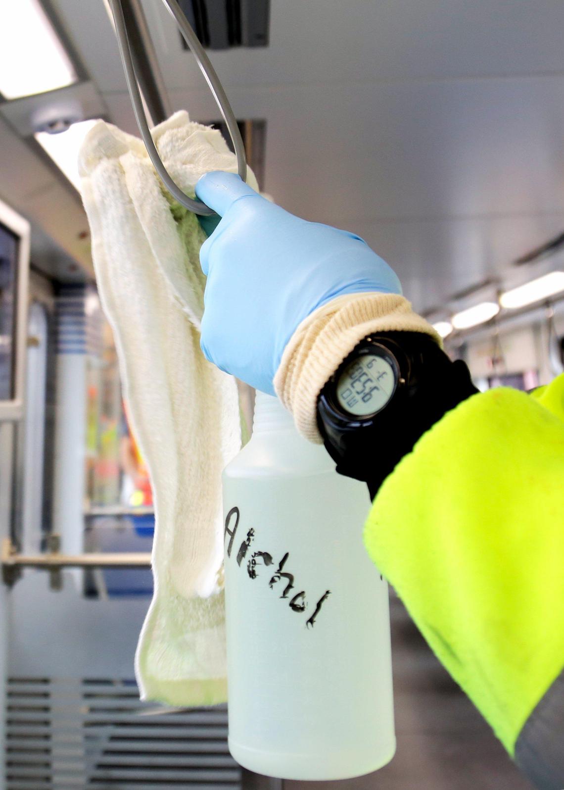 Rail car cleaner Andre Henry, 45, uses alcohol to wipe the interior of a rail car stationed at Miami-Dade County’s Lehman Rail Yard.